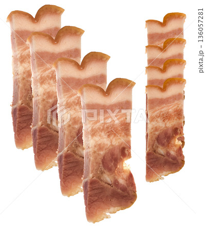 Slice of bacon with meat layers on white plate isolated 136057281