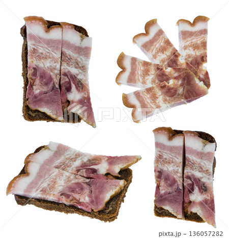 Slice of bacon with meat layers and a slice of black bread on white background isolated 136057282