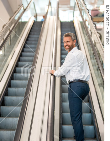 Airport and business travel. International business trip. Metro train station. Airport terminal escalator. Businessman escalator in subway station. Elegant man in business center. Man shopping mall Airport and business travel. International business trip. Metro train station. Airport terminal escalator. Businessman escalator in subway station. Elegant man in business center. Man shopping mall 136057478
