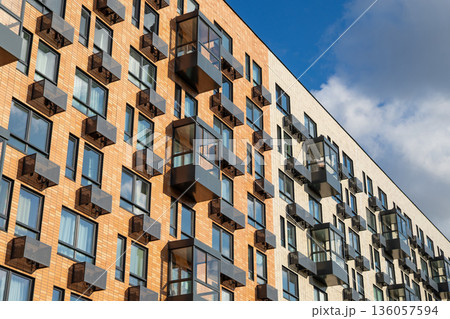 Modern residential building with many windows, air conditioner boxes. Urban architecture and real estate development. Contemporary renovation apartment complex. Modern residential building with many windows, air conditioner boxes. Urban architecture and real estate development. Contemporary renovation apartment complex. 136057594