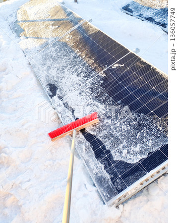 Clean snow off solar panels with a brush broom Clean snow off solar panels with a brush broom 136057749