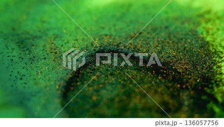 Glitter fluid defocused. Paint blob. Yellow green shiny particles blend abstract background. Bright pigment mix color on black circle blotch. Glitter fluid defocused. Paint blob. Yellow green shiny particles blend abstract background. Bright pigment mix color on black circle blotch. 136057756