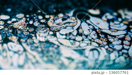 Gasoline fluid blur. Chaotic bubble texture. White orange soap paint spill on black blue background. Abstract fizz chemical liquid. Gasoline fluid blur. Chaotic bubble texture. White orange soap paint spill on black blue background. Abstract fizz chemical liquid. 136057761