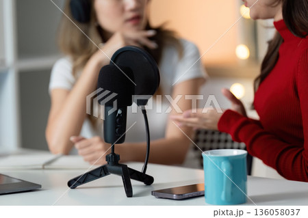 Two women are talking on a microphone 136058037