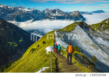 Hiker group on the famous Stoos mountain ridge in Switzerland Hiker group on the famous Stoos mountain ridge in Switzerland 136058496