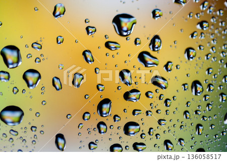 Beautiful multi-colored water droplets on a glass Beautiful multi-colored water droplets on a glass 136058517