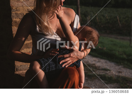 Mother Breastfeeding Child in an Outdoor Setting Mother Breastfeeding Child in an Outdoor Setting 136058688