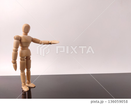 Wooden mannequin with welcome sign hand on a white background with copy space. 136059058