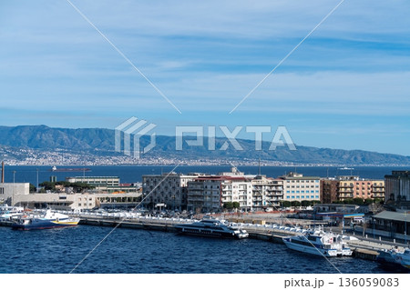 Messina port waterfront with ferries and Strait of Messina, Italy Messina port waterfront with ferries and Strait of Messina, Italy 136059083