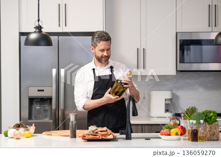 Healthy food diet. Man cook tasty meal. Home menu with seafood food. Man cook cooking at kitchen. Hispanic man standing in kitchen preparing sea food. Man cook tasty crab leg. Seafood feast Healthy food diet. Man cook tasty meal. Home menu with seafood food. Man cook cooking at kitchen. Hispanic man standing in kitchen preparing sea food. Man cook tasty crab leg. Seafood feast 136059270
