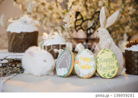 Sleeping white bunny with Easter cookies and spring holiday table decor 136059281
