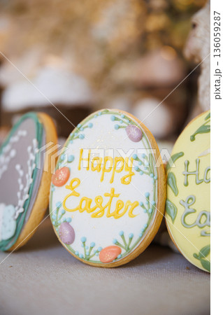 Close up of Happy Easter iced cookie with pastel spring decoration Close up of Happy Easter iced cookie with pastel spring decoration 136059287