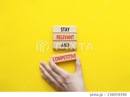 Relevant and Competitive symbol. Concept words Stay Relevant and Competitive on wooden blocks. Beautiful bright yellow background. Businessman hand. Business and Stay Relevant and Competitive concept. Relevant and Competitive symbol. Concept words Stay Relevant and Competitive on wooden blocks. Beautiful bright yellow background. Businessman hand. Business and Stay Relevant and Competitive concept. 136059390