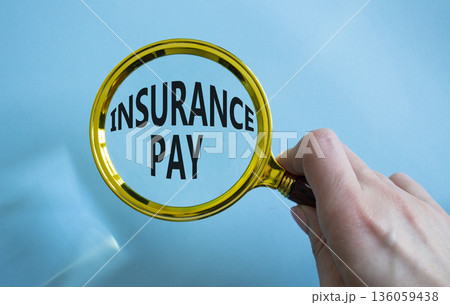 Insurance Pay symbol. Magnifying Glass with words Insurance Pay. Businessman hand. Beautiful blue background. Business and Insurance Pay concept. Copy space. Insurance Pay symbol. Magnifying Glass with words Insurance Pay. Businessman hand. Beautiful blue background. Business and Insurance Pay concept. Copy space. 136059438