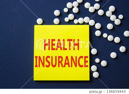 Health Insurance symbol. Concept word Health Insurance on yellow note. Beautiful deep blue background with pills. Medicine and Health Insurance concept. Copy space 136059443