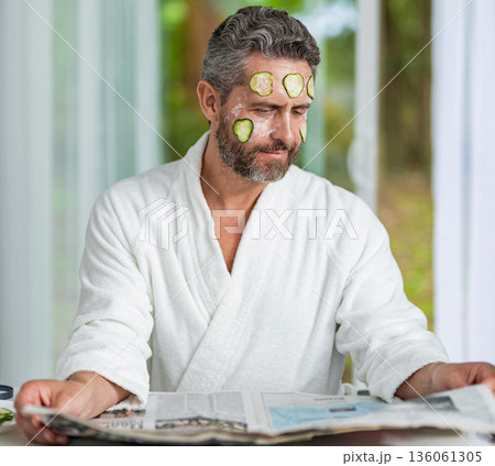 Hispanic man with facial cucumber mask. Benefits of vitamin C. Man applying facial mask cucumber. Face treatment. Facial mask of cucumber. Cosmetic procedure man with cucumber slices mask on face Hispanic man with facial cucumber mask. Benefits of vitamin C. Man applying facial mask cucumber. Face treatment. Facial mask of cucumber. Cosmetic procedure man with cucumber slices mask on face 136061305
