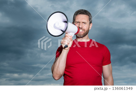 man in red shirt announce in loudspeaker on sky background man in red shirt announce in loudspeaker on sky background 136061349