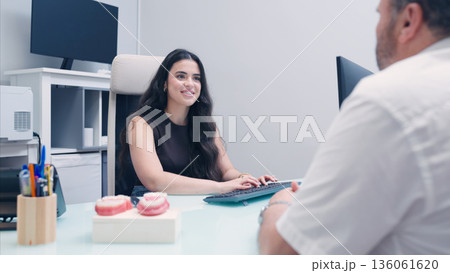 Dentist explaining dental treatment to patient Dentist explaining dental treatment to patient 136061620