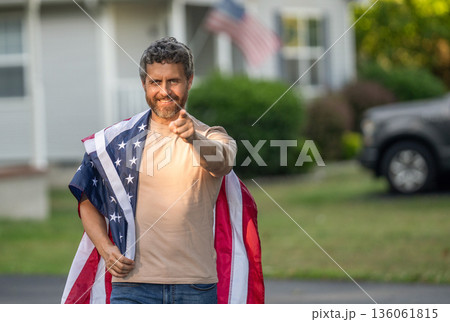 American Flag for Independence Day or 4th of July. Man hold American flag outdoor. Patriotic man with patriotic symbol point finger. American independence. National flag. Independence day, banner American Flag for Independence Day or 4th of July. Man hold American flag outdoor. Patriotic man with patriotic symbol point finger. American independence. National flag. Independence day, banner 136061815