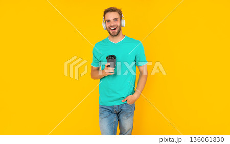 happy guy with bristle listen music drink coffee on yellow background, morning happy guy with bristle listen music drink coffee on yellow background, morning 136061830