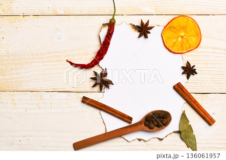 Composition of condiment on paper piece. Wood spoons with pepper Composition of condiment on paper piece. Wood spoons with pepper 136061957