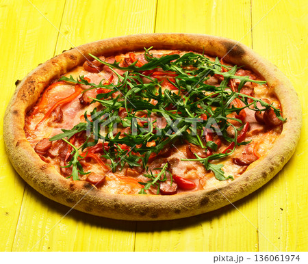 Spicy pizza with rucola and seasoning. Pizza with bacon, cheese Spicy pizza with rucola and seasoning. Pizza with bacon, cheese 136061974