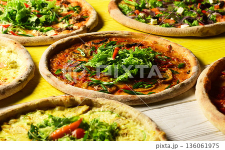 Pizza circles with meat, green onions, tomatoes and salad Pizza circles with meat, green onions, tomatoes and salad 136061975