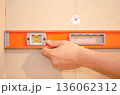 Checking Wall Alignment with Spirit Level 136062312