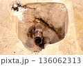 Exposed Plumbing Pipes in Concrete Floor 136062313