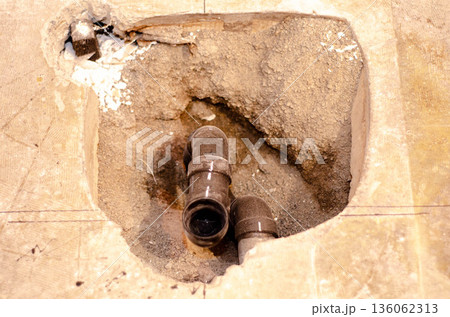 Exposed Plumbing Pipes in Concrete Floor 136062313