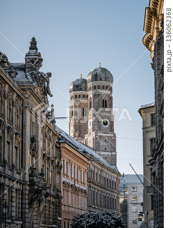 Historic Munich Old Town Street With Cathedral Of Our Dear Lady: Narrow Urban Alley Framing Iconic Twin Domed Church Towers And Traditional Bavarian Architecture 136062368