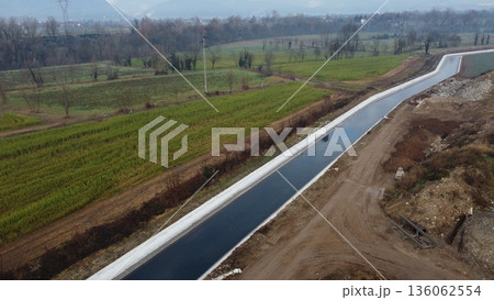 Aerial view of an irrigation canal in the rural landscape of Bedizzole, Italy Aerial view of an irrigation canal in the rural landscape of Bedizzole, Italy 136062554