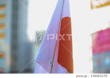 【日本の国旗】冬の空の街並みになびく国旗 136063270