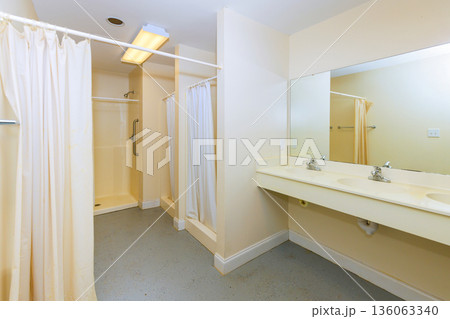 Two separate areas for showers, sinks are for personal hygiene in shared space. 136063340