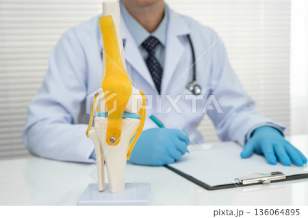 Knee osteoarthritis, Doctor showing model knee joint orthopedic. Knee osteoarthritis, Doctor showing model knee joint orthopedic. 136064895