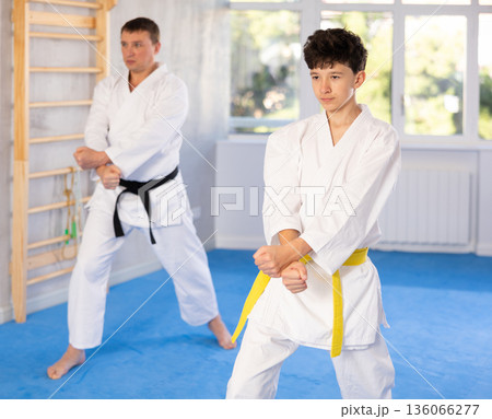 Man and boy teenager train karate technique 136066277