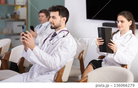 Medical students take pictures of information during meeting or lecture 136066279