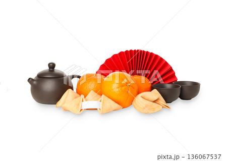 Teapot with cups, mandarins, cookies, and fan, isolated, PNG 136067537