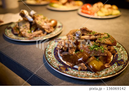 Hearty and warm traditional family dinner with roasted lamb and potatoes, Enjoy warm and comforting family meal featuring rustic roasted lamb and potatoes served hot 136069142