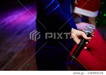 Intimate performance scene, Candid moment of performer amidst lively nightlife background, Confident singer showcased in dim neon lighting with friends enjoying performance 136069156