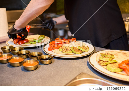 Cooking market scene, Vegetables being grilled and prepared, Vibrant outdoor kitchen with fresh vegetables, Busy market area where vegetables are expertly grilled and prepared 136069222