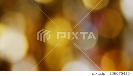 Defocused glow circles. Vibrant yellow light. Orange purple color round bright texture glimmer gleam reflection on abstract bokeh background. Defocused glow circles. Vibrant yellow light. Orange purple color round bright texture glimmer gleam reflection on abstract bokeh background. 136070430