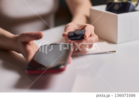 Lavalier attachment to phone for rapid interview recordings. Onsite interview preparation involving portable microphone and quick assembly tools in natural lighting conditions 136071086