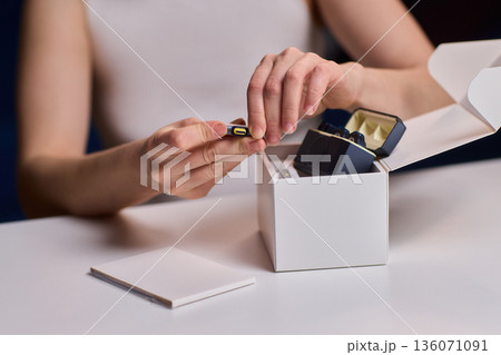 Professional microphone placement process. Technician carefully arranges microphone on desk. Precise setup of audio equipment for broadcasting or retail display Professional microphone placement process. Technician carefully arranges microphone on desk. Precise setup of audio equipment for broadcasting or retail display 136071091