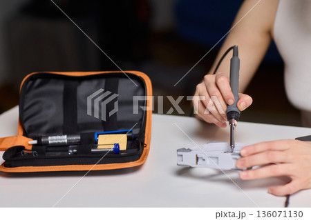 Precise fan motor wiring craft, Closeup of careful electrical soldering work, Meticulous assembly of fan motor components through precision soldering and careful alignment 136071130