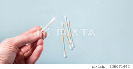 Hand holding bamboo cotton swab for hygiene 136071443