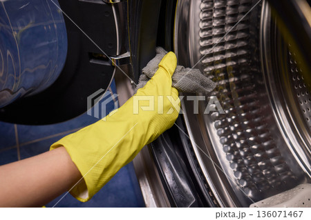 Using gloves to clean and protect gasket seals from mold, Thoroughly maintain gasket surfaces by sanitizing with cloth and hand wiping to prevent mold and moisture buildup 136071467