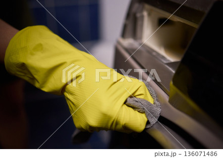 Using gloves to clean and protect gasket seals from mold, Thoroughly maintain gasket surfaces by sanitizing with cloth and hand wiping to prevent mold and moisture buildup 136071486