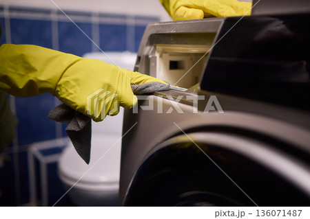 Using gloves to clean and protect gasket seals from mold, Thoroughly maintain gasket surfaces by sanitizing with cloth and hand wiping to prevent mold and moisture buildup Using gloves to clean and protect gasket seals from mold, Thoroughly maintain gasket surfaces by sanitizing with cloth and hand wiping to prevent mold and moisture buildup 136071487