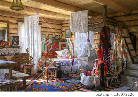 The interior of a 19th-century Russian hut with a bed and a cradle suspended from the ceiling The interior of a 19th-century Russian hut with a bed and a cradle suspended from the ceiling 136072226